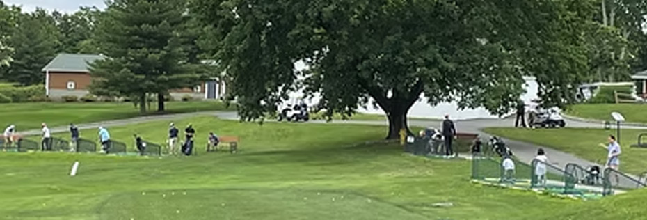 golfers hitting balls at driving range